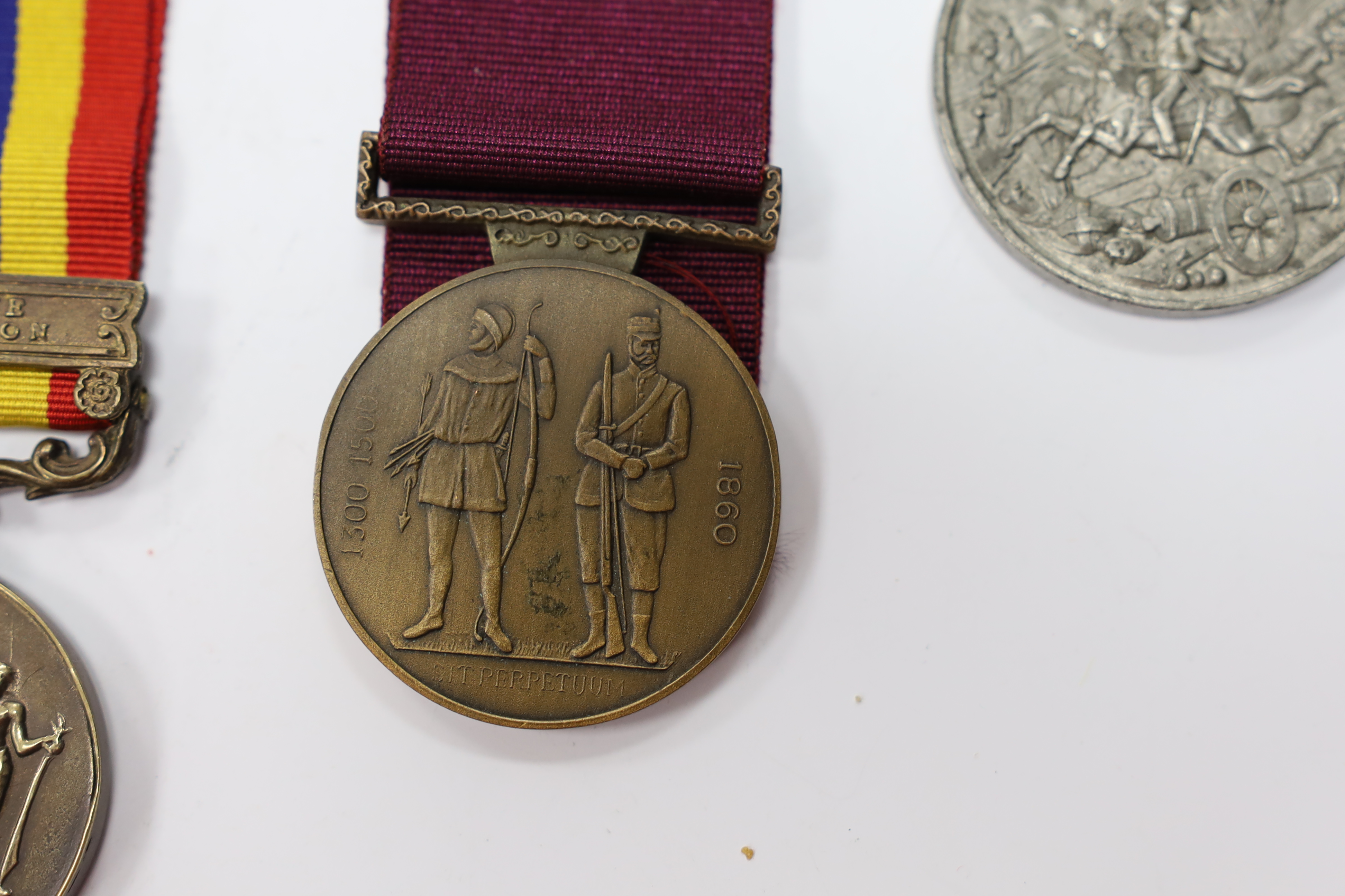 Assorted medals; two replica British North Borneo medals; Balaklava medallion; bronze GV medal; German China Campaign medal; bronze NRA medallion, unnamed